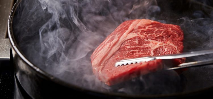 wagyu steak cooking in pan